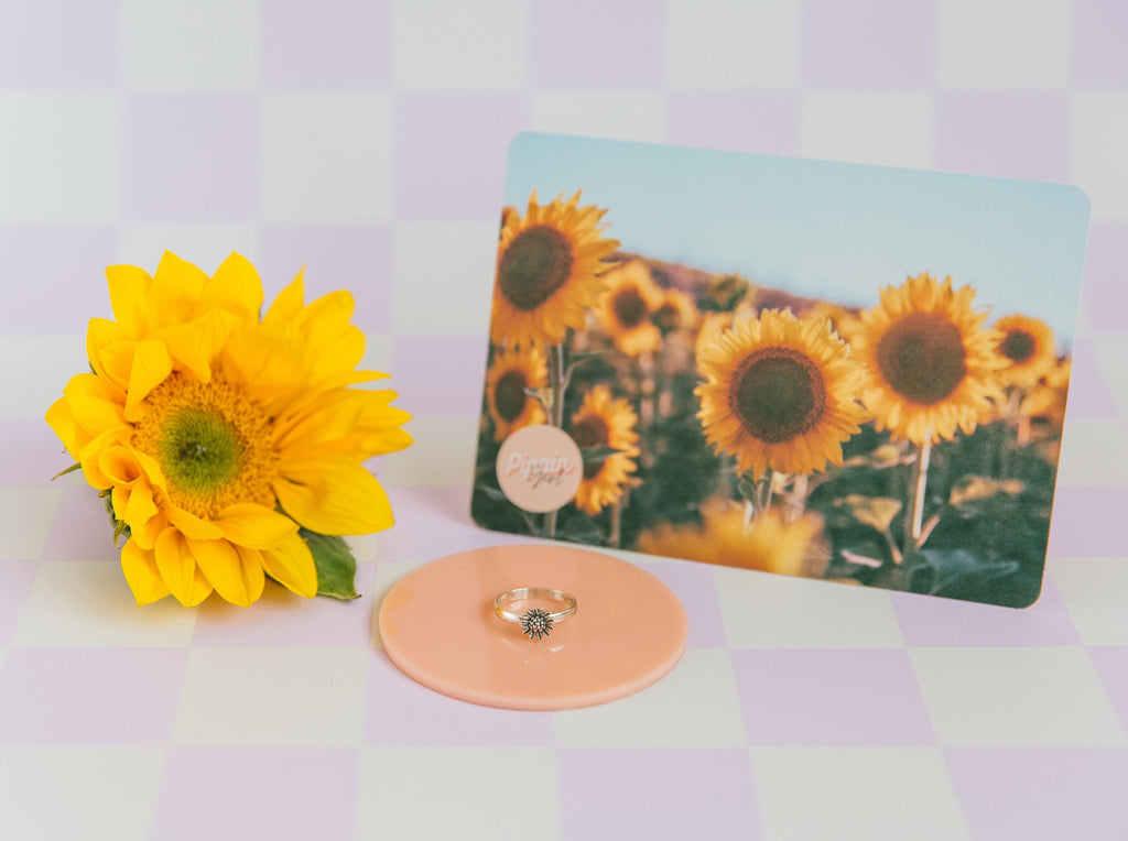 Pippin Girl Bloom Ring styled with a yellow flower and sunflower affirmation card