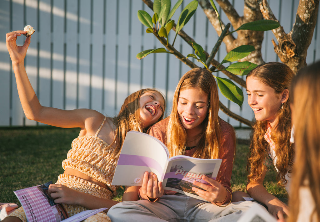 Girls having fun hanging out and reading Pippin Girl Bloom Collection books in the afternoon sun