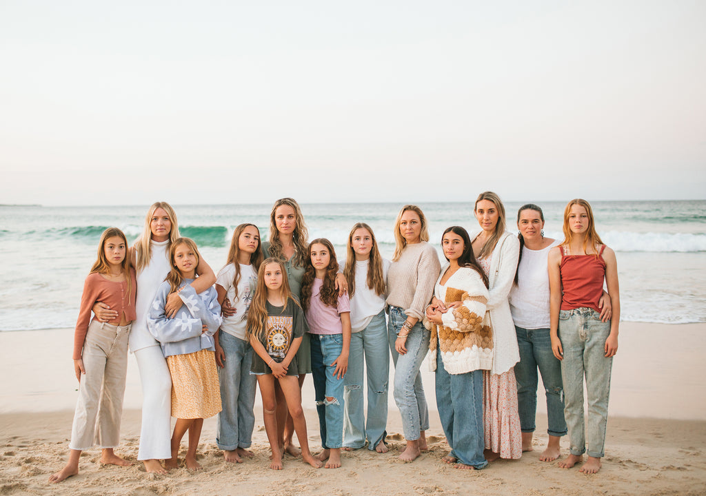 Group of mothers and daughters at the beach